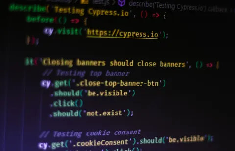 A close-up photograph of Cypress end-to-end test code displayed on a screen.